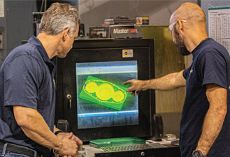 Two TorqLite technicians troubleshooting a hydraulic wrench design, essential for usage training.