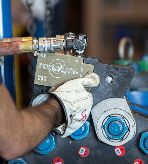 Torqlite hydraulic torque wrench on LNG pipeline, demonstrating precision for liquefied natural gas applications.
